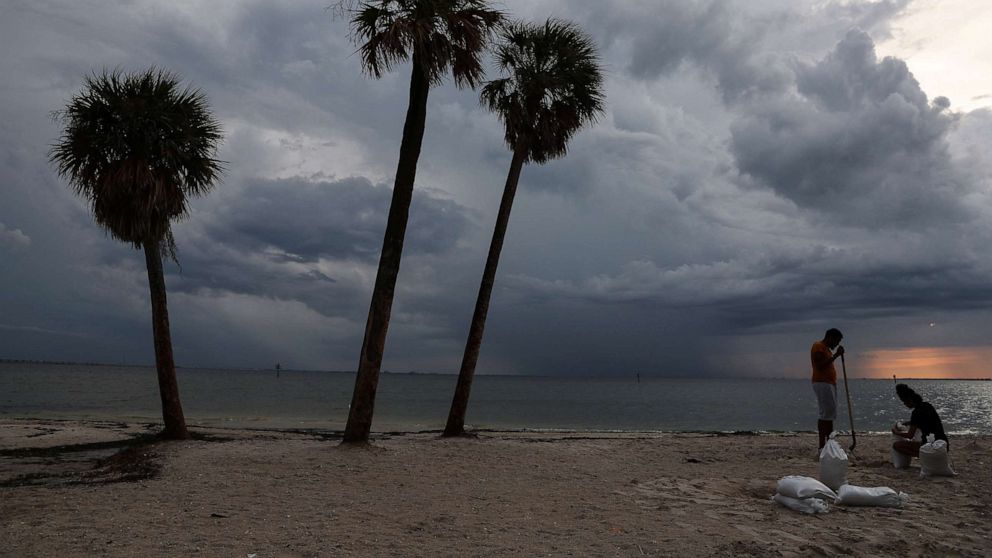ФОТО: Местные жители наполняют мешки с песком, когда ураган Ян приближается к штату, принося сильный ветер, проливной дождь и мощный штормовой нагон, на пляже Бен Т. Дэвис в Тампе, Флорида, 26 сентября 2022 года. 